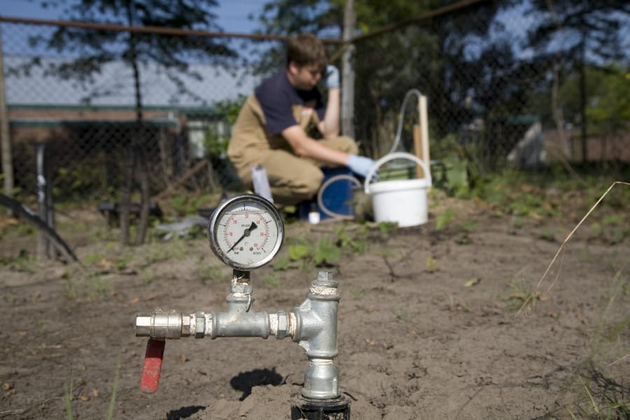 A man samples groundwater for testing